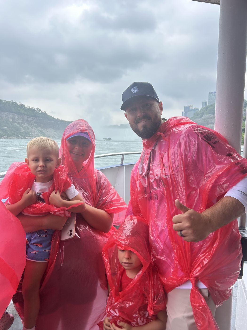 Une famille en imperméables rouges à bord du bateau, tout près des chutes